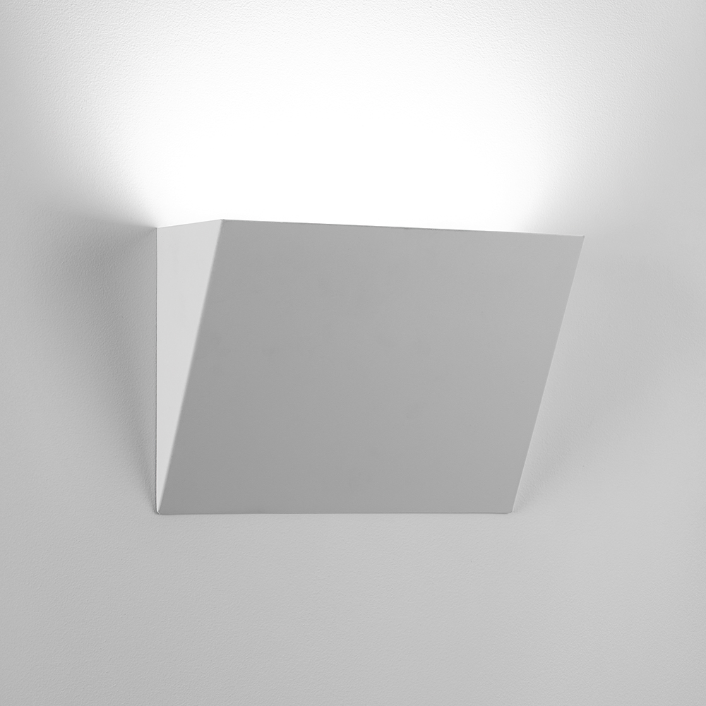 A sharp, angled indirect wall sconce with a solid body