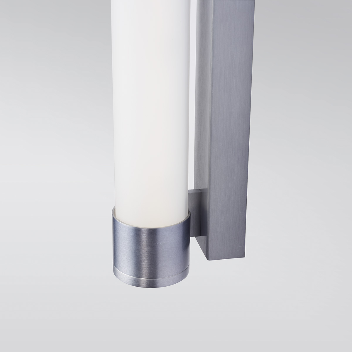 A luminous wall sconce in a thin tube shape with metal caps on each end