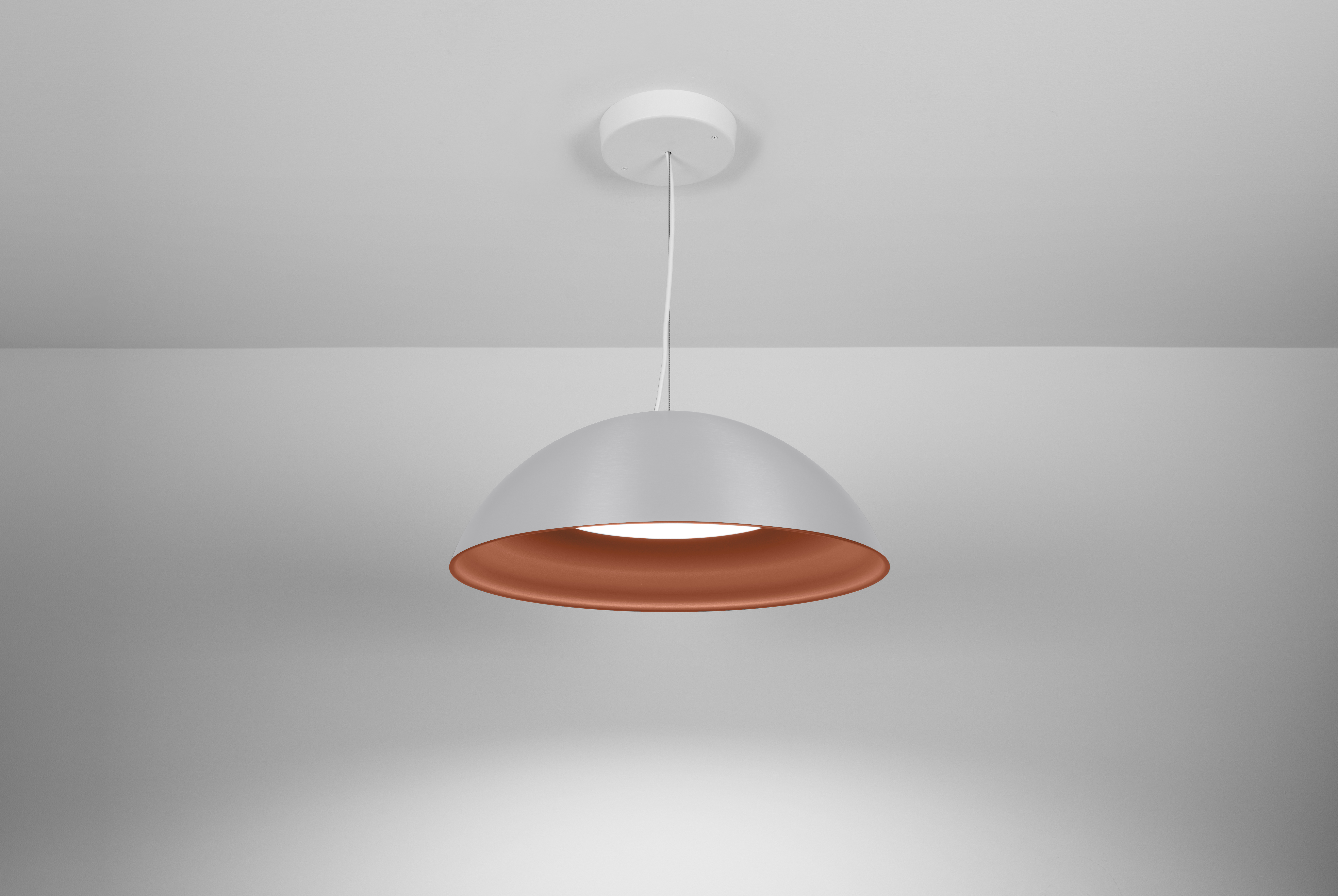 Hand-spun aluminum dome and inner contour with a flat lens distributing even illumination