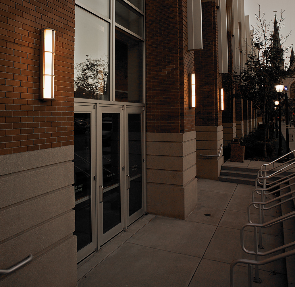 Avatar exterior lighting fixtures illuminate a campus library doorway with a classic, sophisticated aesthetic.